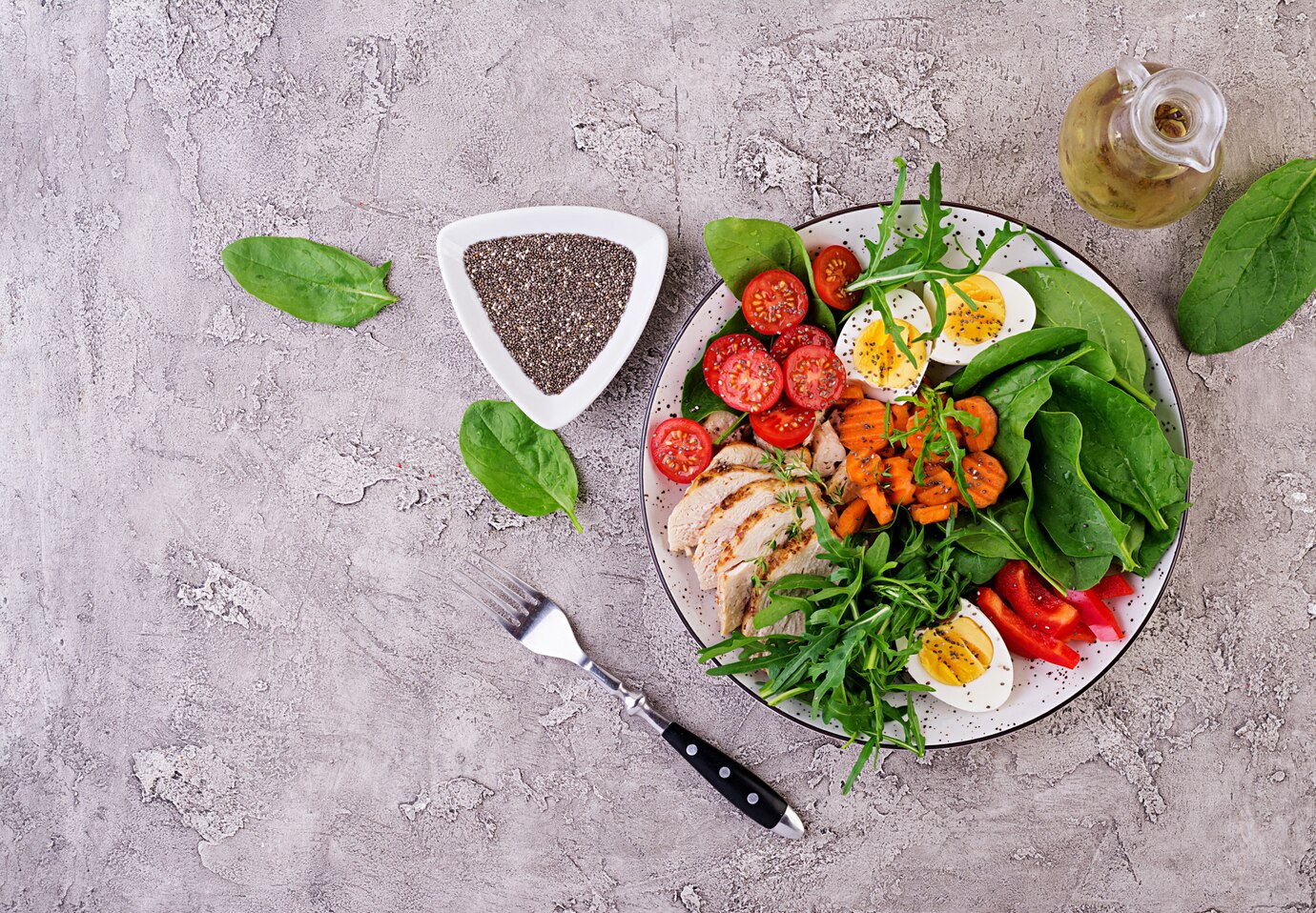 plate-with-keto-diet-food-cherry-tomatoes-chicken-breast-eggs-carrot-salad-with-arugula-spinach-keto-lunch-top-view_2829-16938